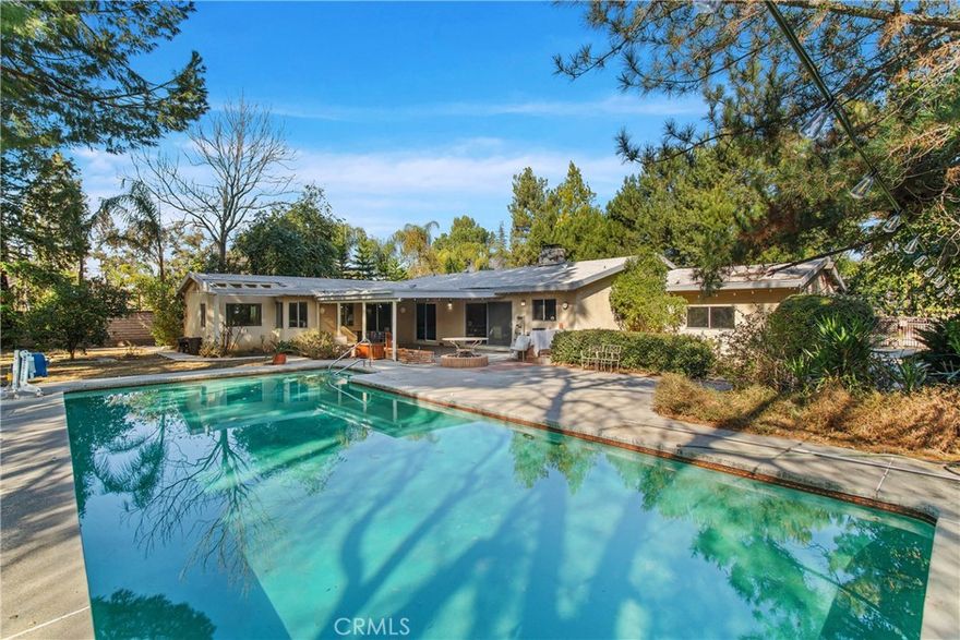 First time on the market in over 60 years! This spacious 4-bedroom, 2-bathroom home spans 2,453 sq. ft. on an appx 21,000 sq. ft. lot in the highly sought-after Walnut Acres neighborhood.

Tucked away on a secluded flag lot, this property offers privacy and endless potential—ideal for builders, developers, or families looking to create their dream home. The interior boasts an extra-large living room, a separate family room with a double-sided fireplace, and a generously sized primary suite.

Step outside to an incredible backyard featuring a large covered patio, a sparkling pool, mature fruit trees, and a lush grassy area. With ample space to park an RV and a boat, this home is filled with natural light and charming original details, ready to be transformed into something truly special.