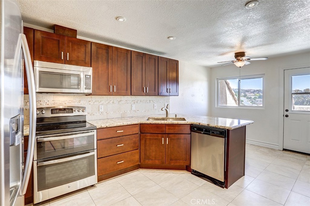 Enjoy ocean breezes and the San Clemente lifestyle less than a half-mile to the beach. Turnkey and ready to move in to enjoy as a first or second home. Spacious and bright 3-bedroom, 2 bathroom condominium with an open floor plan. Freshly painted and newly carpeted. Beautiful golf course and panoramic views from kitchen, dining room, living room, and spacious back patio. Completely remodeled kitchen with granite countertops, stainless steel sinks, custom backsplash and features both a kitchen nook and breakfast bar. Recessed lighting throughout. Bathrooms have been remodeled with granite countertops and custom sinks with a beautifully designed shower in the master bath. Separate laundry room with storage is located just off the kitchen. Doors from kitchen, living room and dining room lead to the large balcony that extends the length of the condo for BBQs or just relaxing. One-car garage (with new garage door) plus a private parking space. HOA dues both trash and water. The community offers 2 pool areas with spas. Walking distance to the beach, and close to dining, shopping, golf, San Clemente outlets, Dana Point Harbor, freeway access and all that Southern California has to offer. No Mello Roos and FHA and VA approved. A true must-see!