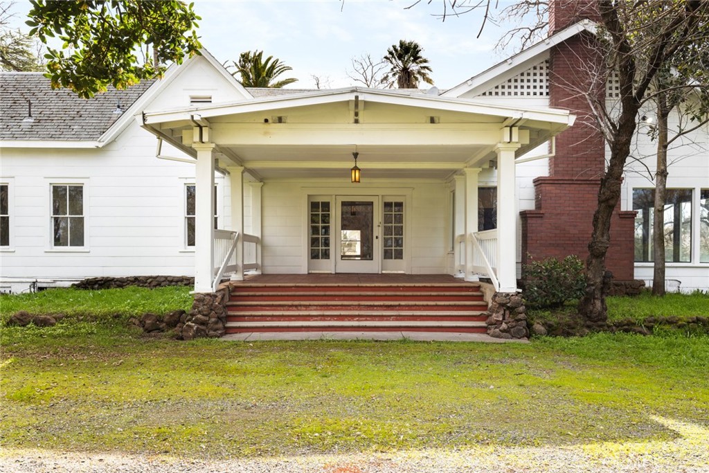 1920s Craftsman on 40 Acres – Just One Parcel from Chico City Limits! If you’ve ever dreamed of restoring a piece of history, this 1920s Craftsman style home is your chance! From the moment you step onto the grand front porch, you’ll feel the timeless character of this estate. Overflowing with original charm, this home boasts rich woodwork, built-ins, vintage fixtures, and a stately brick fireplace that no doubt has warmed nearly a century of stories. The grand living room, reminiscent of a ballroom, features stunning coffered wood ceilings, while floor-to-ceiling windows invite in natural light and serene views. The formal dining room is a true showstopper, with intricate craftsmanship, pocket doors, and plenty of space to host unforgettable gatherings. Below it all, a very large basement offers endless possibilities....storage, a workshop, a wine cellar, or even additional living space.
With a little vision, this home is ready to shine once again. A grand entrance lined with towering old palm trees sets the stage for this one-of-a-kind property, blending vintage California charm with endless potential. Beyond the main home, the expansive land offers incredible possibilities, including a quaint old guest home, just waiting to be brought back to life, and a very rustic barn, perfect for storage, animals, or even a stunning event space with a little creativity. Whether you dream of a private retreat, a working homestead, or a legacy estate to pass down for generations, this rare find is brimming with opportunity. If you're ready to restore and reimagine a true classic, this Craftsman is calling your name. Don’t miss your chance to own a piece of history!