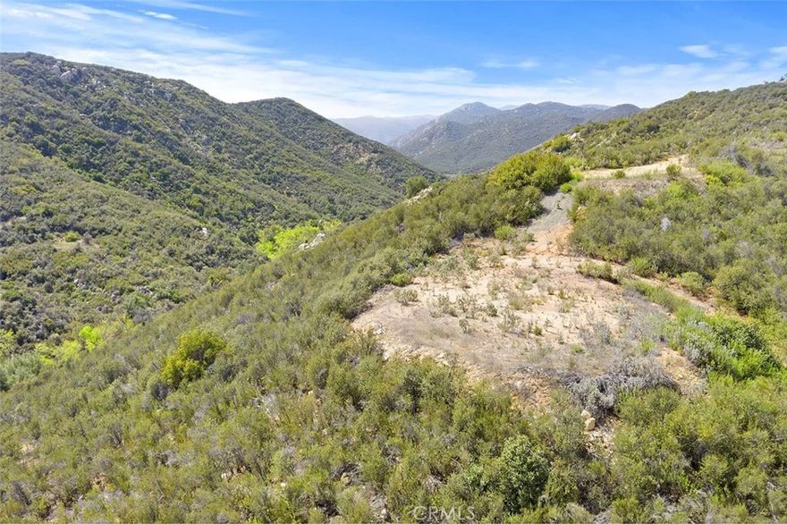 SELLER FINANCING AVAILABLE!!!! 9+ ACRES OF PRIVACY & VIEWS. THIS ONE IS GORGEOUS AND PRICED TO SELL!  Enjoy stunning mountain views from this nine-acre parcel on the Santa Rosa Plateau. Adjacent 9-acre parcel also available! Build your dream home and enjoy the “La Cresta Lifestyle” of open spaces, clean air, serenity and star-filled skies. This part of the Plateau is very quiet and feels worlds away, yet it is actually just minutes to the convenience of schools, restaurants, hospitals, shopping, Historic Old Town Murrieta and the 15 Freeway. This area is also within the La Cresta Highlands POA, where their current minimum square footage for primary residences is only 2000 square feet, making getting started easy and cost-effective. Paved roads lead to the property. City water is at the street and the water bond has been paid! Let your imagination run wild, as you consider building an off-grid home, taking advantage of innovative solar and battery technology.  Your country dream home is calling!  *** 5-acre minimum parcels (10-acre minimum in SR West), just minutes to schools, restaurants, hospitals, grocery stores, 15 Fwy & Temecula Wine Country. Enjoy this peaceful ranch community with no commercial businesses, robust social activities, miles of private community trails & 1000s of acres of Ecological Reserve…All less than 1.5 hours from LA, SD, OC, Palm Springs & Big Bear. Discover the country, yet convenient, lifestyle of La Cresta, Tenaja & the Communities of the Santa Rosa Plateau!