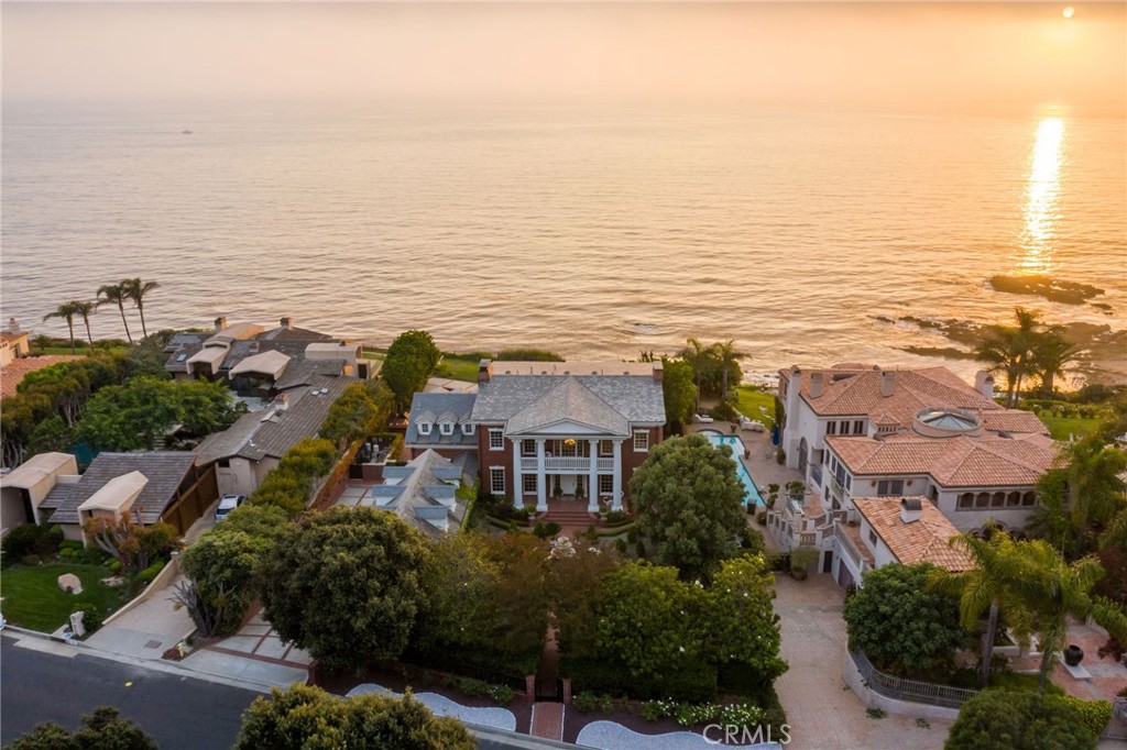 Rarely does a home in this location become available in our coastal region. This magnificent traditional style home offers an extraordinary level of Luxury & comfort & is situated in a rare and breathtaking bluff top location. Stunning views of the expansive Pacific ocean and the Palos Verdes shoreline, the views offer an exceptional and rare perspective of the amazing Southern California coast-created by centuries of Nature's forceful efforts. This 6000 square foot home(BTV) has 5 bedrooms, 5 1/2 baths, a wood paneled office, 4 fireplaces & an impressive list of amenities and features. One of the bedrooms is a separate guests quarters above the 3 car garage with its own entrance. The home sits on an acre of the Southern California Coast where the property line ends at the median high tide line. The backyard features a large outdoor "cook's kitchen," a large pool and Jacuzzi and expansive yard area for entertaining. There is a private path that leads to the secluded beach below. The home brings a warmth and intimacy often absent in such a grand residence. The large ocean view master bedroom has a whitewater view, large Ocean View balcony, a fireplace and his & hers closets. Close to the extraordinary Terranea Resort & the 4 world class golf courses of Palos Verdes, the lifestyle & location are hard to match anywhere. There is a community tennis court and clubhouse for the 30(approx) homes in this exclusive community. Only 18 homes on the Bluffs in Lunada Pointe. Only 2 bluff-top homes have sold in the last 10 years. The original developer of Lunada Pointe choose this home and location as his personal residence.