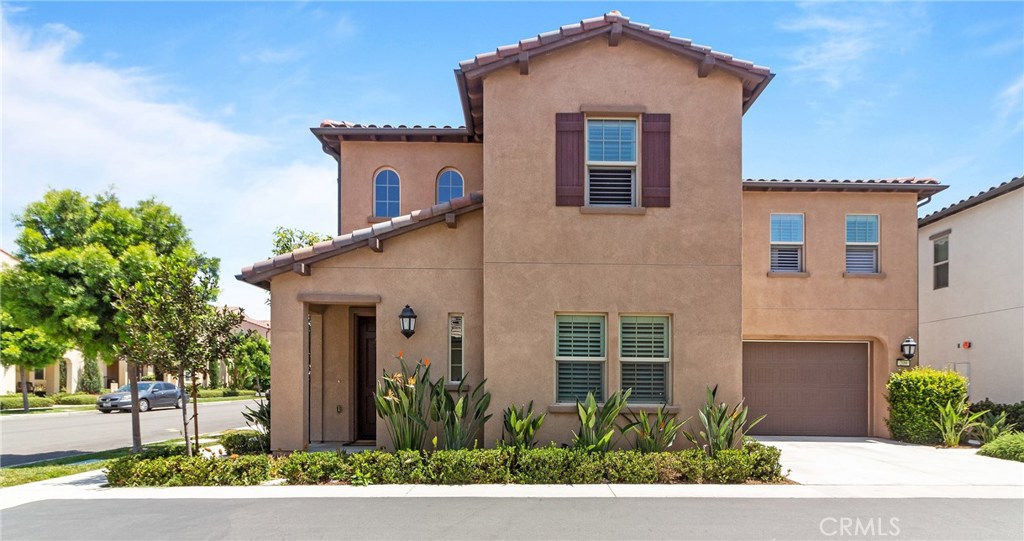 Two-level detached home in the desirable neighborhood of Colibri in Portola Springs - Irvine, is ready for its New Owners! Wood floors, upgraded baseboards, crown molding, modern paint colors and recessed lighting compliment the bright and open floor plan. The upgraded kitchen features fresh white Thermofoil cabinets, stainless steel appliances, granite counters and backsplash, a center island with bar seating and separate dining area with slider to the large private patio which is perfect for relaxing or entertaining. The spacious living room flows seamlessly from the kitchen and features several light-catching windows. Convenient main level bedroom offers privacy for any guest with an adjacent full bath that completes the downstairs. The master suite features wood floors, plantation shutters, sizeable walk-in-closet, and upgraded en-suite spa like bath with soaking tub and oversized walk-in-shower with tile surround. The secondary bedrooms are a generous size and share the full hall bath. All bedrooms are pre-wired with Cat5 and RG6 "data jacks" to accomodate cable TV, internet access and home automation options. Additional features include - water softener, chloride filter, full size laundry room w/ wash sink on second level, tankless water heater and 2 car attached direct access garage with plenty of storage. Award-winning Irvine Unified schools. Close to Woodbury Shopping Center which includes many dining options, Trader Joes, Home Depot, and much more! Welcome Home!
