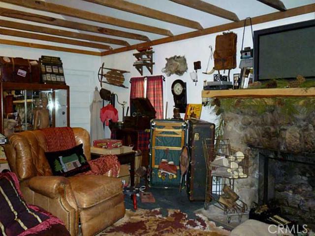 Adorable 1 Br/1 Ba Cabin Situated On A Large Lot With Babbling Pond Out Front. Over The Years This Home Has Been Updated With Modern Day Conveniences, But It Did Not Lose Any Of It's Charm. This Home Has An Open Floor Plan Which Starts With A Full Service Kitchen With Breakfast Bar. Then On To The Living Room Which Has An Open-beamed Ceiling, Painted Wood Floors, And A Cozy Rock Fireplace. To Top It All Off, This Gem Has Air Conditioning And A Fenced-in Backyard With Large Deck, Spa, And Sauna.