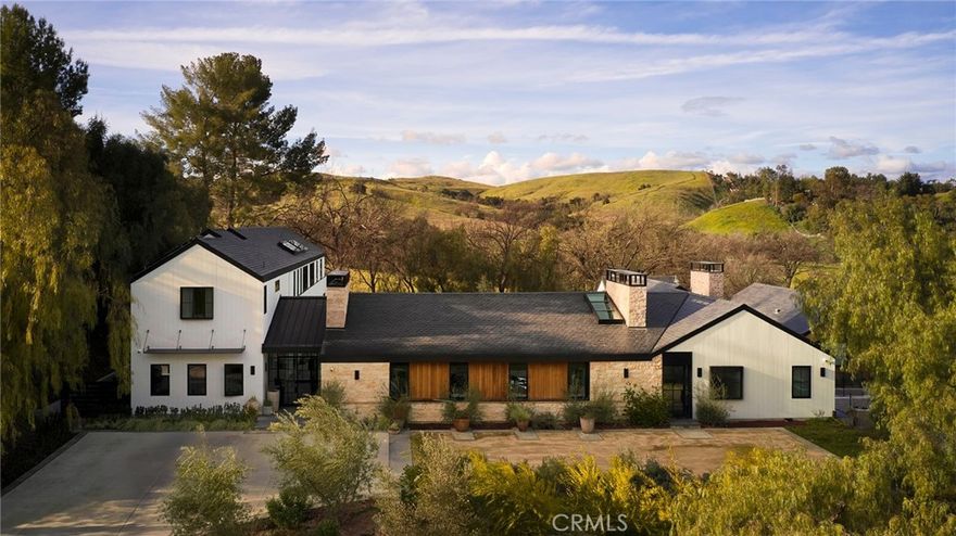 Located within the coveted community of Hidden Hills, "The Reserve" at 5727 Jed Smith Road, is an estate unlike any other.  This modern Napa Valley-inspired ranch compound is the pinnacle of California Living.  This newer-built estate, which is situated on over an acre of land, features an open great room, gourmet kitchen outfitted with Gaggenau appliances, and automatic glass doors which lead into a lush resort-style backyard complete with zero-edge pool, outdoor cabana with complete kitchen and fireplace, incredible guest house, and neighbored by conserved land.  Luxury amenities include:  an elevator, four kitchens, three laundry rooms, gym with an infrared sauna, home theater, laundry jet, refrigerated wine cellar, whole home purified water system, dog run, plaster hand-troweled walls throughout and a six-car garage with carousel.  The approximate 2,000 sq. ft. primary suite incudes a kitchenette, oversized dual shower, marble bathroom with heated floors, hidden TV, two fireplaces and a private and peaceful patio with stunning views.  This estate is one of a kind and a must see!