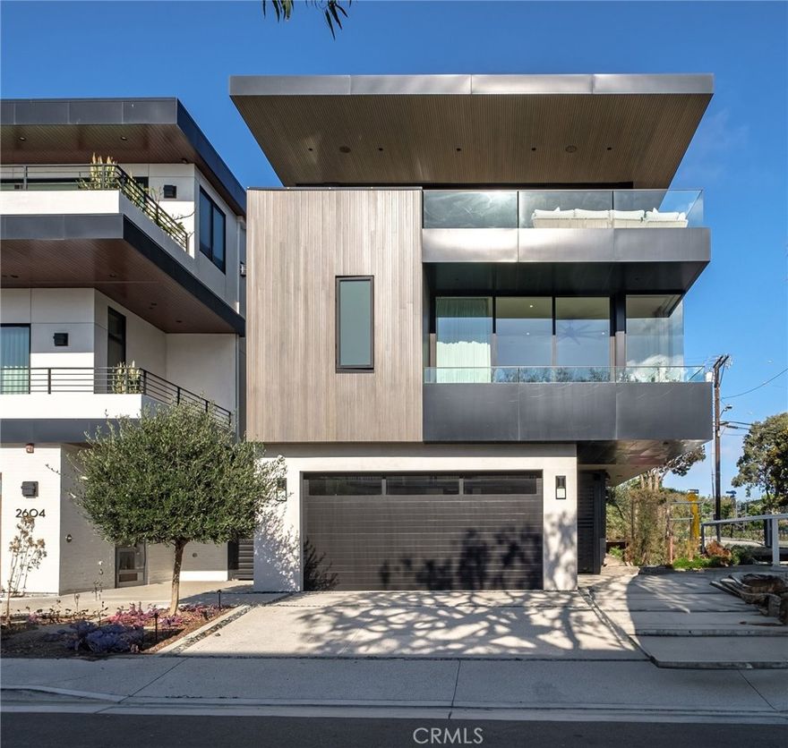 Prepare to be amazed by this stunning front townhouse featuring 4 bedrooms and 4.5 baths, all within 2,682 sqft and boasting breathtaking views! Enjoy daily ocean vistas and gorgeous sunsets from this exceptional property. Built in 2021 by JW Powers Development on a prime corner lot in the MB Sand section, this home is filled with high-end upgrades that elevate luxury living.



The expansive gourmet kitchen is a chef's dream, equipped with top-of-the-line appliances, including a Wolf range, Sub-Zero refrigerator, wine fridge, and two Asko dishwashers. On the middle level, you'll find three of the four bedrooms, each with its own en suite bath.



Additional features include a convenient 3-stop elevator, an attached two-car garage, and an extra-large driveway apron that accommodates up to three additional vehicles, providing a total of five parking spaces. The spacious foyer on the entry-level offers direct access to the garage and a versatile downstairs bedroom that can double as an office. This home is the epitome of coastal elegance!