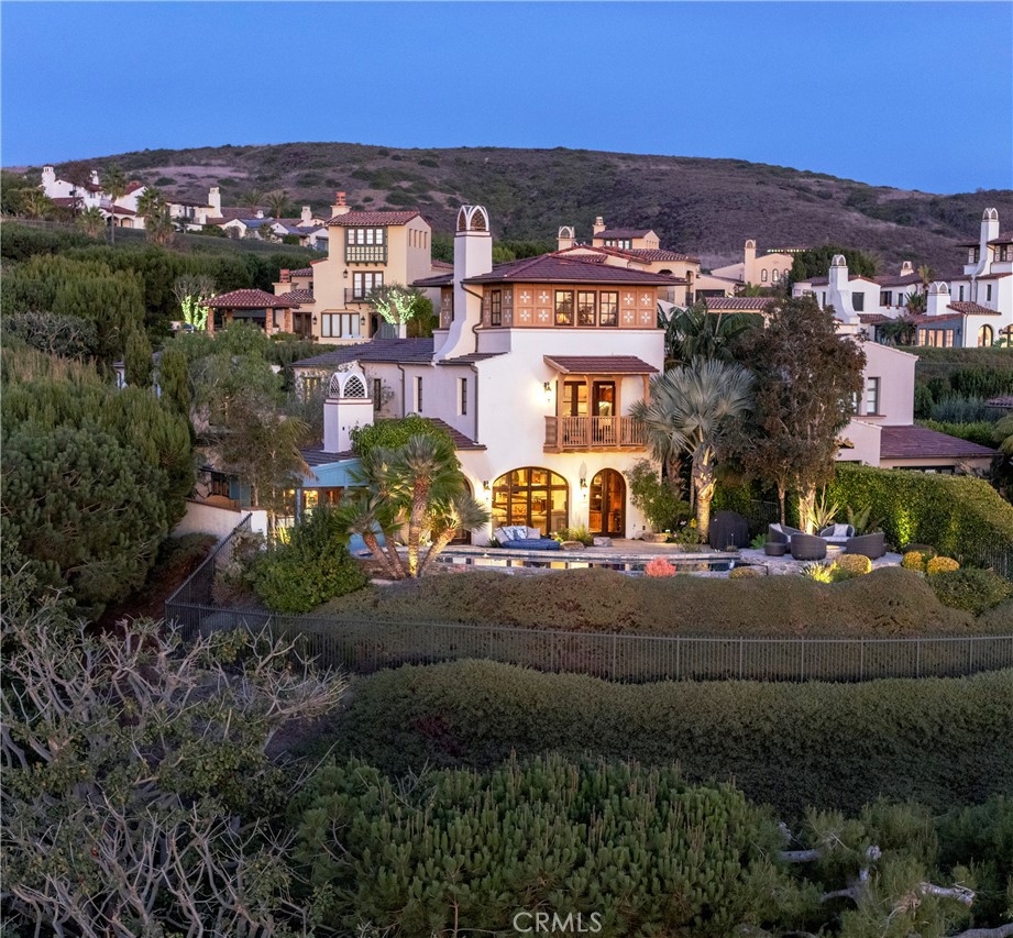 Situated on an over-sized, secluded corner estate lot with a long front drive of over 100 feet, this warm and inviting Crystal Cove home has much to offer, including 3 bedrooms and 3.5 baths, a 3rd story loft/office tower, detached casita, flexible bonus room and rare 4-car garage. While well-maintained and move-in ready, the home is in generally original condition from 2003, making it a great candidate for a renovation and/or expansion project, should someone desire. Either from inside the home or out by the glass tiled infinity edge pool, this property enjoys spectacular ocean, Catalina and sunset views. Crystal Cove is a private, guard gated and patrolled community with much to offer its residents and guests, including the 2.5 acre Canyon Club for swimming, tennis, basketball, entertaining and meetings. In addition, there are 4 parks, several green belts and numerous hiking trails. Conveniently located just outside of the community gates, the Crystal Cove Promenade offers many casual and upscale options for dining and shopping, and is within easy walking distance from the property. Crystal Cove State Beach sits just across Pacific Coast Hwy.