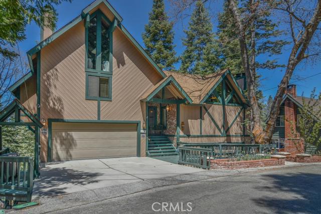 Amazing Lodge Style Home in Golf Course Neighborhood! A quick stroll or golf cart cruise to Lake Arrowhead Country Club, and Grass Valley Lake. A choice home with level and direct entry via two car garage, master suite with loft & private deck, formal living room, family room, three fireplaces, full bar, three viewing decks, and ample use of windows to enjoy forested setting and peaks of the golf course. Furthermore, a full house generator, video security system, keen eye to maintenance, vaulted and beamed ceilings, cottage style kitchen, hot tub, and lake rights!