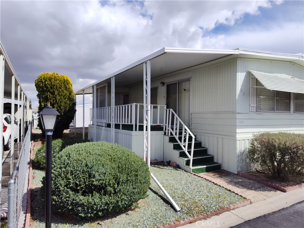 Welcome to your serene oasis in Country Club Estates, nestled in the heart of Yucca Valley's coveted 55+ mobile home community. This charming 2-bedroom, 1-3/4 bath home boasts 1,200 square feet of comfortable living space.
Step inside from the front patio deck to the spacious living room with wood shutters that allow you to control the natural light. The heart of the home is the large kitchen, offering generous counter space and storage. Adjacent lies a convenient indoor laundry area.
Retreat to the main bedroom suite, your private area for sanctuary and tranquility. Unwind and recharge after a fulfilling day. The second bedroom provides versatility and is ideal for guests or as a cozy den to indulge in hobbies, leisurely pursuits or perhaps as an office.
Beyond the comforts of home, Country Club Estates presents a lifestyle of leisure and recreation. Situated within walking distance of Hawks Landing Golf Club, enthusiasts can tee off amidst picturesque landscapes and pristine greens. After a round of golf, savor a delectable meal at The Roost Cafe at Hawks Landing.
Embrace the vibrant spirit of Yucca Valley, where natural beauty and modern conveniences await. From scenic hiking trails to eclectic boutiques and galleries, there's always something new to explore here. Whether you're seeking adventure or simply seeking solace in the serene desert landscape, Country Club Estates offers a sanctuary to call home. Don't miss your chance to experience the best of 55+ living in this coveted community. Schedule your showing today and make this tranquil retreat yours. Park space rent is a very reasonable $650 per month.