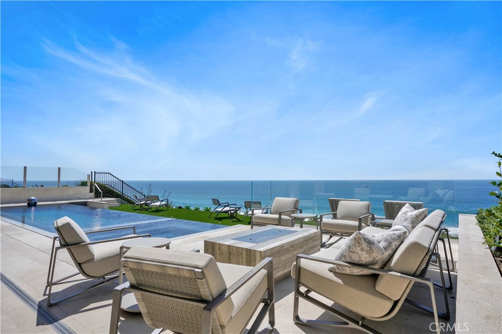 GORGEOUS REBUILD AND REMODEL IN 2019! Next door to the Ritz Carlton Resort, the extraordinary coastal Oceanfront jewel 17 Ritz Cove boasts incredible design and luxury and overlooks the waves of the World Famous Salt Creek Beach. Watch the sapphire blue surf, dolphins and sunsets with a straight on Catalina view. Ritz Cove has only 101 homes and is the only 24-hour guard-gated community that is nestled between two Five Star Resorts and a premier golf course. Meticulously designed with select and custom furnishings, accented by magnificent custom light fixtures, accessories and art, this Turnkey Trophy home is being sold FULLY FURNISHED. This beachfront estate has 5 Ensuite bedrooms, an office, brand new enormous windows, & huge sliding doors that open to magnificent ocean breezes. This home is a masterpiece! The refined designer kitchen features Thoemmes fine cabinetry & quartzite countertops. The elevator whisks you from the first floor to the master suite. The master bedroom's views stretch the length of the coast to the white water waves rolling in to Shell Beach and Monarch Bay. The Master Suite has both a bedroom area and a living room-sized sitting area, plus a view patio. Lower level large media room is complete w/waterfall edge bar, conditioned wine room, game & viewing area. A subterranean garage houses three cars & an electric car charger. Rebuild completed in September 2019. Brand new pool. The attention to detail is apparent at every turn!