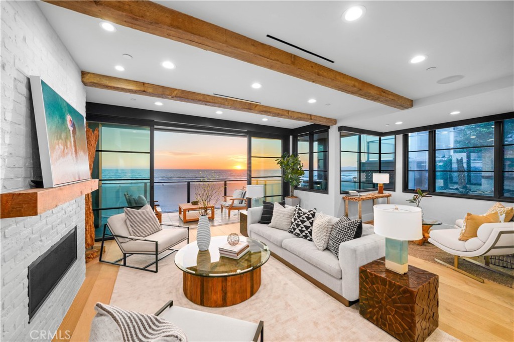 Modern luxury meets cutting edge architecture and exquisite quality at Manhattan Beach’s most coveted “Center of the Bullseye” Strand location. This three story beachfront oasis was created w/ a commitment to a modern, hearty exterior designed to withstand the oceanfront environment. This stunning residence blends in alluring reclaimed wood beams, antique French doors, blackened steel railings, doors & windows, floor-to-ceiling glass, imported natural stone & rustic Bastide Collection wood flooring. Each floor offers panoramic beach & ocean views. Perhaps most appealing of its charms, is the home’s placement, steps away from marvelous downtown MB. Designed by Jon Starr & custom built by Steve Larkin, this home offers the opportunity to literally live the dream. The gourmet kitchen features an imported Viking Tuscany Series 66” super-sized range, custom-made riveted hood, Subzero fridge, Bosch dishwasher & Hoshizaki ice maker. The living room features an inviting painted brick fireplace, sitting area & sliding ink-black steel doors offering captivating marine life viewing. One can chillax while watching life go by or utilize the expertly placed built-in BBQ counter bar to grill up a meal on the attached deck. At the top floor, one finds a breathtaking master suite, w/ spa-like marble encased master bath w/ soaking tub, ample shower, a custom built master closet, a relaxing nook & a private deck. The Strand level consists of 2 beds/2 baths, a laundry room & a joyous beach room w/ TnG walls & ceilings. Designed by Jon Starr of Starr Design and built by Steve Larkin of SRL Construction, this gorgeous home was meticulously built new - utilizing just the concrete slabs, and some framing. Come by for a look and you will appreciation the custom design choices made by the Owners, and the attention to detail that went into completing this luxurious home.