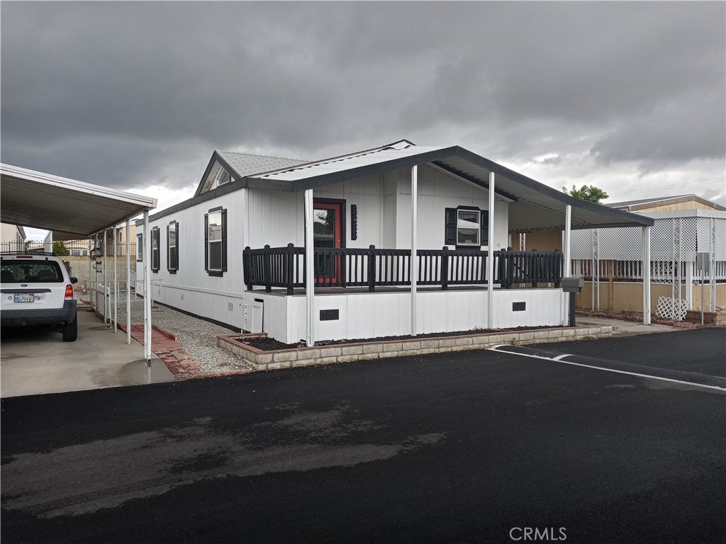 Come see this gem a beautiful 3 bedroom 2 bath, 2000 Build with an open floor plan. Centrally located near shopping, restaurants, and activities throughout the areas. The home features central air and heating, plush carpet, Sunlight, natural light, built-in cabinets, spa style tub, a roomy covered deck and carport awning perfect to enjoy a crisp morning or an awesome sunset. The kitchen is spacious with plenty of storage space and a practical buffet style oven breakfast island. The community features community pool and spa, laundry room, billiards room, clubhouse with library and tv room, and a commercial stove and kitchen for hosting events.