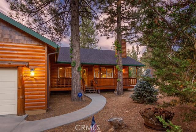 Eagle Point. Exquisite is the name that will come to mind when you enter into this log-style home/cabin. Elegant in-cabin lifestyle decor. Nestled within a peaceful cul-de-sac setting. Gently sitting on just over 1/4 acre of tree-lined land. This remarkable home offers approximately 1,644 sq ft of comfortable living space, with 3 bedrooms, two full baths (Mast. ba., Jet-Tub). Beautiful real wood flooring, throughout. A finished 2 car attached garage has plenty of room for your summer lake toys and your winter fun gear. Big Bear Lake is SoCal's premiere 4 seasons resort town, offering two ski resorts and an all-sports public access lake, surrounded by mountain ranges. This home sits right in the center of everything Big Bear Lake has to offer, no need to look any further!