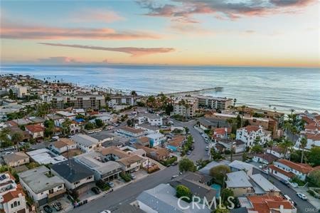 Seeking a beautifully furnished medium-term rental, available for 30 days or more, mere steps from the beach, a vibrant downtown area, and easily accessible major highways? Welcome to your ideal coastal retreat at 325 W Avenida Palizada. This newly renovated 3-bedroom, 1-bathroom home offers a comfortable coastal ambiance, both indoors and outdoors, in an ideal location to fully embrace San Clemente's offerings. You’ll also be a short drive from Disneyland, Lego Land, San Diego Zoo, and more! Upon arrival, you'll immediately appreciate the charm of this coastal cottage, embracing its original 1950s design. Step through the Dutch door into the spacious open-concept living room boasting a vaulted ceiling and a white-washed brick fireplace. The room features a generously sized sectional with a queen memory foam sleeper and a 65" smart TV. Abundant natural light streams through the large west-facing windows. The kitchen showcases stunning aquamarine herringbone tile walls, floating white oak shelves, and a suite of brand-new LG appliances (refrigerator, freestanding stove, dishwasher), complemented by a delightful built-in dining nook. Adjacent to the kitchen, an expansive enclosed front patio offers multiple seating areas and breathtaking sunset views. The bedrooms provide comfortable dimensions and a bright, airy coastal atmosphere, complete with window treatments offering blackout options. Bedroom one includes a queen bed, a large dresser, an armoire, and nightstands. Bedroom two features a full-size bed, dresser, nightstands, and a clothing rack. The third bedroom boasts beautiful French doors opening to the front of the property, a functional workspace with a stand-up desk, an in-unit washer/dryer, and additional storage. The bathroom showcases a walk-in shower, new vanity, and finishings. Stepping out through the back hallway or the third bedroom leads you to the spacious backyard adorned with local succulents and plants. Bask in the morning sun or evening warmth within the covered patio and seating area. Additional amenities include a second seating area with a fire pit, a Traeger smoker/BBQ. Surfboards included! Parking options include a long driveway with space for 2 vehicles and street parking.