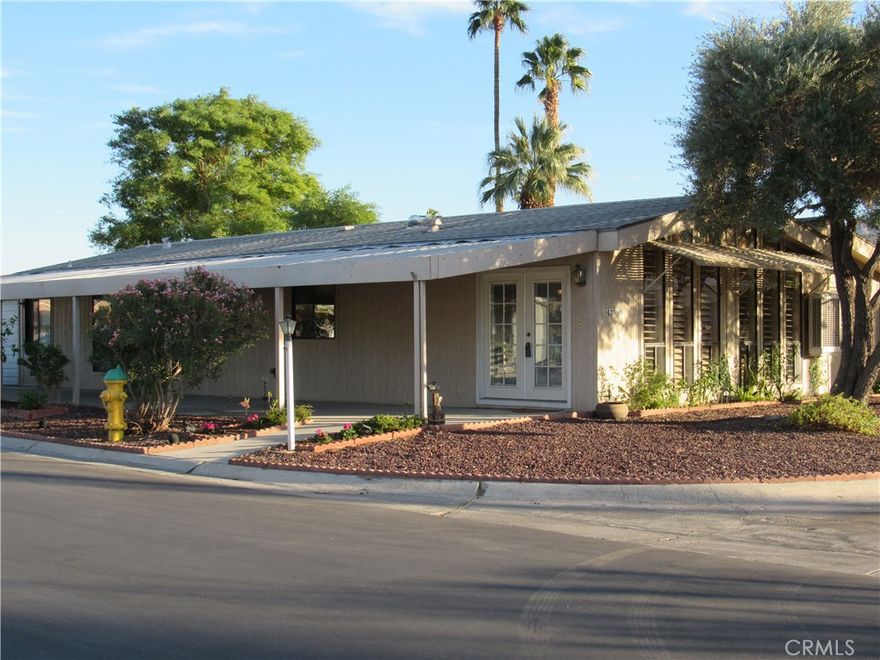 MOTIVATED SELLER! PRICE REDUCTION! WILL CONSIDER ALL OFFERS! GREAT INVESTMENT OPPORTUNITY! Location, Location, Views! This spacious home sits on the corner of Diadomite Way and Angels Camp Road, with spectacular views of the surrounding mountains - all of which can be taken in from your living room and front porch. The location is in a prime area of the community with only one neighbor and a lot close to amenities such as the pool, hot tub, green space and pickleball. The living room and dining room feature cathedral ceilings and expansive windows with beautiful plantation shutters. The kitchen is fully functional and operational with a wall oven, gas cooktop, dishwasher and laminate countertops. The family room is large with built in bookcases and direct access to the kitchen and dining room. An additional room off the family room is available for additional seating, a quiet reading room, a craft room, a bonus room or an office. Let your imagination organize the space to suit your needs and lifestyle. The primary bedroom is comprised of a large closet and an en-suite bathroom with double vanities, soaking tub, separate shower and vanity area. The guest bedroom has access to its own bathroom with shower. The utility room has enough space for a washer/dryer and lots of storage with a built in desk. The extended driveway and carport can park 4 cars. Additionally, the partially enclosed carport has an automatic garage door. Another important variable is that you own the home and the land in this community. The Portola Country Club community features gated access and many amenities such as unlimited golf for two on the 18-hole par 3 course, tennis, pickle ball, several pools, spa, clubhouse and RV parking. In addition to the amenities listed, the monthly HOA fee also covers cable, internet and trash. The location is magnificent, close to restaurants, shopping and El Paseo. Golf cart available! This home offers a lot of opportunity and is priced well-below comparable properties within the community! Come in and put your spin and decorative touches on this property and truly make it your own.  Call to schedule an appointment today.