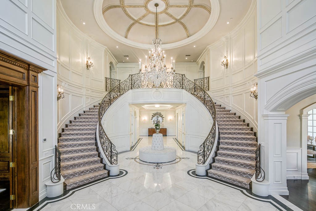 Sensational Georgian Manor in 12,438 Square feet of opulence. This distinctive property in Arcadia's prestigious Upper Rancho area features 6 bedrooms and 8.5 baths. You realize upon entering the wide circular driveway the presence that this magnificent estate commands. Grand entryway with chandelier and 28 foot rotunda ceiling will be whispers of delight among guests. Culinary energy flows in the Master chef’s kitchen featuring Wolf and Sub-Zero appliances. Relax in your family room with wet bar and media center. Sliding doors open to dining al fresco. Glass/wrought iron wine room is unique. 10-person home theater is a cinematic experience. Guests are pampered in the downstairs suite with spa bath. Ascending the dual grand staircase or private elevator, to your expansive master suite for complete relaxation and incomparable spa bathroom. All bedrooms are ensuite. Home yoga/gym offers dry sauna. Private home office/library is adorned with amazing wood and northern light. Outdoor bbq and dining bar with kitchen is for perfect entertaining poolside. Separate pool house matches main estate in quality and luxury. Pool/ spa with Baja shelf will be the center of coveted summer activities with its custom drop-down cinematic movie screens. State of the art home automation is stellar with the latest iPort system. All rooms offer remote controlled electric blinds as well. This is truly one of Arcadia’s finest estate offerings.