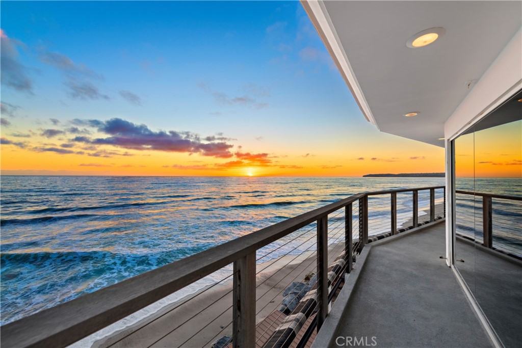 Unparalleled in Capistrano Beach, this freshly remodeled oceanfront home captures the California Dream on Dana Point’s guard-gated Beach Road. Approximately 3,059 square feet, the soft-contemporary design maximizes the rewards of its location by featuring floor-to-ceiling windows and French doors in the living and dining rooms that capture panoramic ocean, whitewater, Dana Point headlands, Catalina Island, and sunset views. The living room opens to a sunny Trex-finished deck, with grounds of about 4,100 square feet continuing to the median high-tide line on the sand, adding a touch of private beach paradise to the three-bedroom, four full-bath residence. Open and light, the main level also features a linear fireplace with onyx surround, a two-car garage, and a high-end kitchen with stone countertops, an island, pantry, new white cabinetry, a breakfast bar, built-in Sub-Zero refrigerator, plus additional Sub-Zero refrigerator and freezer drawers, two dishwashers, and a double convection oven and microwave from Jenn Air. An elegant spiral staircase takes residents and guests upstairs, where a large bonus room showcases a built-in entertainment center, a fireplace and a built-in desk. Two ensuite guest rooms are featured, and the magnificent primary suite welcomes two walk-in closets, a marble fireplace, and phenomenal ocean and coastline views from the interior and master deck. The spa-inspired bath includes heated marble floors, a stand-alone spa tub and a separate shower. All four baths are remodeled and host backlit LED mirrors, Walker Zanger tile, and polished Antolini stone. Other features enhance the home’s style and value, including an exterior shower, a Sunbrella retractable awning, Lutron motorized shades, and fresh exterior paint. Dana Point's popular harbor, the coastal towns of Laguna Beach and San Clemente, and countless entertainment, recreational, shopping and dining opportunities are just minutes away.