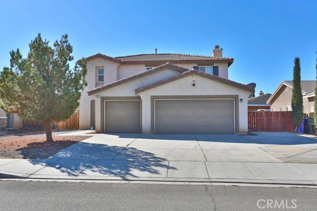 Your search stops NOW! This Gorgeous two story home built in 2006 on OVER a 7,000 square foot lot with attached 3 car garage has everything you need and more. Upon entering you are greeted by a formal dining room and living room with plenty of room allowing you to entertain your loved ones. The open layout kitchen has a generous amount of countertop space, breakfast bar, eating nook area with built in desk, and is open to the living room. The spacious living room is accented by a cozy fireplace for those calm desert nights and perfect for movie night! The first floor features a large bonus room that could be the 5th bedroom and also a bathroom convenient for family and guests, the additional 4 bedrooms and 2 bathrooms are on the second floor. As you walk upstairs there is a roomy loft with a built in desk perfect for school projects or a home office space! Enter into the massive master bedroom and master bathroom with dual sinks, separate tub and stand up shower. The oversized private backyard features the perfect entertainment setting with tons of concrete patio space for BBQ's, a play-set, and to relax and enjoy the Beautiful Desert Sunsets. This home also features the fridge and security camera system to be included in the sale! This Fantastic home is ready for you to enjoy, View Today!