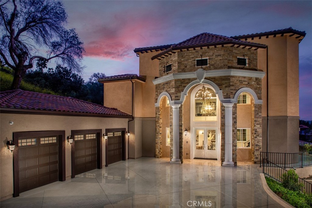 Experience the pinnacle of luxury living in this majestic Tuscan-inspired estate, nestled within the prestigious gated community of The Country Estates in Diamond Bar, CA. Crafted by Grandway, this stunning six-bedroom residence showcases architectural splendor with elegant arches, colonnades, and meticulous details throughout. Situated on approximately 63,000 square feet of meticulously landscaped grounds, this opulent three-story home offers quality finishes and exquisite craftsmanship.
Step into the grand foyer through dramatic double doors, where soaring 30-foot ceilings, elegant marble floors, and a beautiful iron staircase welcome you. Entertain guests in the formal living room, boasting French doors that open to a full-length terrace overlooking panoramic city views. Indulge in culinary delights in the gourmet kitchen, complete with a large island, marble counters, custom cabinetry, and high-end Thermador appliances.
The main level also features a guest bedroom, study/home office, mudroom, and elevator leading to the upper floors. Upstairs, discover a spacious family room, game room, home theater, laundry room, junior suite, and two additional ensuite bedrooms. The secluded Primary bedroom suite on the top floor offers a private living room, double-sided marble fireplace, and a step-out balcony with breathtaking vistas.
Luxuriate in the spa-like Primary bathroom, featuring a freestanding tub set against bay windows, two walk-in closets, his and her vanities, and a steam shower. Additional highlights include hardwood floors, a three-car garage with epoxy floors, three tankless water heaters, five A/C condensers, and state-of-the-art home automation.
Outside, serene terraces, balconies, and patios provide the perfect setting for outdoor living and entertaining. Community amenities include two gated entrances, 24-hour security patrol, clubhouse, tennis/basketball courts, pool, and walking trails.
Don't miss this opportunity to own a piece of luxury in Diamond Bar's most sought-after enclave. Schedule your private viewing today!