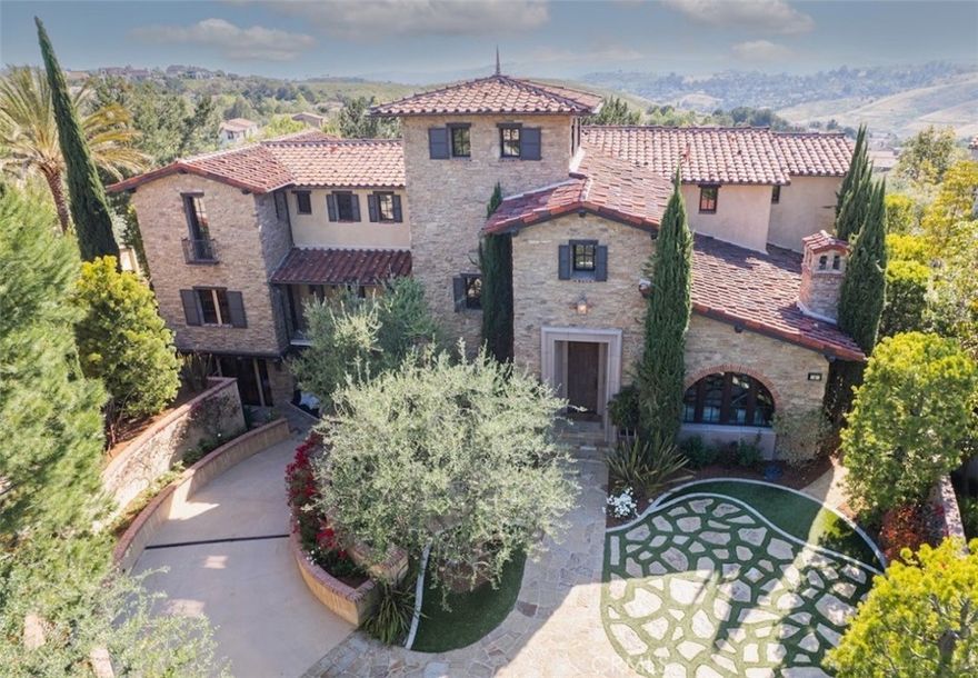 **MULTI-MILLION REMODEL COMPLETED JUNE 2023** Welcome to 4 Thomas, Ladera Ranch, a harmonious blend of stone cottage villa aesthetics and modern farmhouse elegance, nestled in the heart of the secure guard-gated community of Covenant Hills in South Orange County. A multi-million dollar remodel was just completed on this 5 bedroom 7 bathroom home. This grand estate spans nearly half an acre, offering a serene & luxurious setting, located at the end of a quiet cul-de-sac with breathtaking views. Upon arrival, a seven-car subterranean garage greets you, reflecting thoughtful design and commitment to security and convenience. The home reveals its grandeur across four levels, each showcasing meticulous design & detail. The property impresses further with an 800 bottle wine cellar complete with a cigar fumador, a unique luxury for wine and cigar connoisseurs alike. One of the home's standout features is the private home theater, expertly designed to deliver a fully immersive cinematic experience. An elevator provides convenient access across all levels. The gourmet kitchen stands as a beacon of luxury and functionality, outfitted with top-of-the-line Viking appliances including a grand 60" Viking range and oven, and a 100" built-in sub-zero refrigerator & wine cooler. Elegance permeates the space, with Waterworks fixtures and striking European marble countertops enhancing the kitchen's opulence. Throughout the home, handcrafted hardware from England adds a touch of sophistication and craftsmanship. The master suite offers a tranquil sanctuary with an adjoining master bathroom akin to a high-end spa. Outfitted with Waterworks fixtures and featuring a state-of-the-art steam shower. Outside, the property does not disappoint, boasting a sparkling pool, two inviting outdoor fireplaces, and a private putting green, perfectly curating an atmosphere for both relaxation and entertainment. Living at 4 Thomas, Ladera Ranch not only ensures access to all of Covenant Hills' amenities but also offers the peace of mind that comes with residing in a guard-gated community. This magnificent estate set against a backdrop of stunning views and sunsets, represents a rare opportunity to experience sophisticated living in one of Southern California's most prestigious neighborhoods.