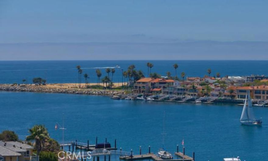 Breathtaking ocean and Catalina Island views throughout this Transitional, European inspired home located in a quiet enclave of selected homes overlooking Newport Harbor. This Corona del Mar residence provides approximately 4,500 square feet of relaxed living space, featuring 4 bedrooms and 5 ½ bathrooms. Upon entering, you are immediately enveloped by thoughtful luxury with herringbone wood flooring, Venetian plaster walls, hand crafted millwork and antique fixtures framing your eye to unobstructed panoramic views. No detail overlooked or expense spared with visual treats grabbing your attention and drawing you into the comfort of this superb residence. The master suite replete with his and her bathrooms, the use of rare stone, custom lighting and antique finishes is the height of refinement. State of the art audio, video and lighting systems complete this one of a kind residence.