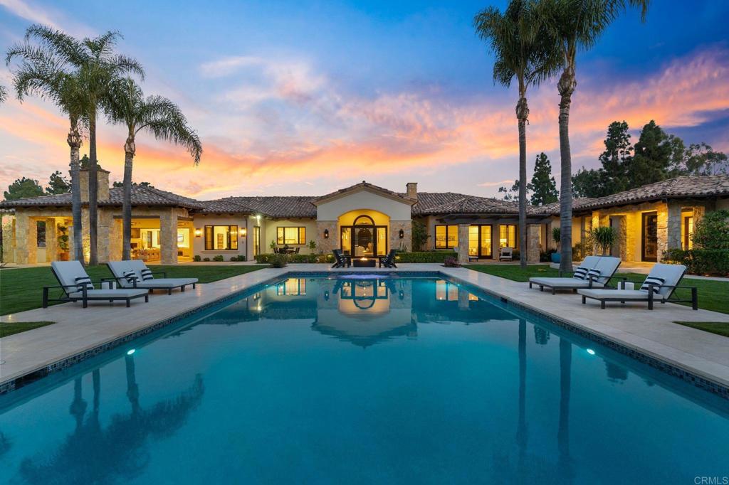 Welcome to your oasis in Rancho Santa Fe, where luxury meets tranquility on nearly 3 sprawling acres of pristine usable land. This meticulously transformed property exudes timeless elegance and modern sophistication, offering the pinnacle of one-story living without a single step to interrupt the flow. Step inside to discover a masterpiece of design, showcasing exquisite craftsmanship and attention to detail. Throughout the main home, Du Chateau wood flooring sets the stage for a seamless blend of contemporary style and natural allure. No surface has been left untouched in the extensive remodel, ensuring a harmonious fusion of form and function. Indulge your senses in the spa-like bathrooms and gourmet kitchen, where warm, natural elements create an inviting atmosphere for both relaxation and culinary delights. The backlit onyx bar and powder room sink add a touch of opulence, while a temperature-controlled wine wall promises to elevate every gathering to new heights. The kitchen is a culinary dream, boasting rift oak cabinetry, a walk-in pantry with an additional oven for the avid chef. Retreat to the primary suite, where spa-inspired features await alongside expansive closets, a private courtyard, and a convenient coffee bar for lazy mornings. Entertainment awaits in the separate gym structure, complete with a sauna that could easily be transformed into a home theater for movie nights with loved ones. For guests, a detached 2- bedroom guest house offers privacy and comfort, featuring its own kitchen and fireplace for cozy evenings in. Outside, the property truly shines with an impressive gated entry, driveways enhanced with antique European bricks, rolling lawns, mature trees and its abundance of amenities. Serve up a game of tennis or pickleball on the private court, then retreat to the large covered outdoor kitchen for al fresco dining under the stars. Recently completed, the resort-like pool beckons with its captivating design and a breathtaking fountain, truly magical at night. Limestone patios surround the pool area, offering the perfect spot for lounging and soaking up the California sun. For the green thumb enthusiast, a greenhouse, rose garden, fruit trees and raised bed vegetable garden offer endless opportunities for cultivation and relaxation. Furry friends will feel right at home with a dedicated dog run, connected privately to the 50 plus mile Covenant trail system, perfect for long walks amidst nature's beauty. Additional features include solar panels for energy efficiency and sustainability, a Tesla Powerwall and well water for irrigation, ensuring a green footprint for generations to come. Don't miss your chance to experience the epitome of luxury living in Rancho Santa Fe. Schedule your private tour today and make this breathtaking retreat your own.