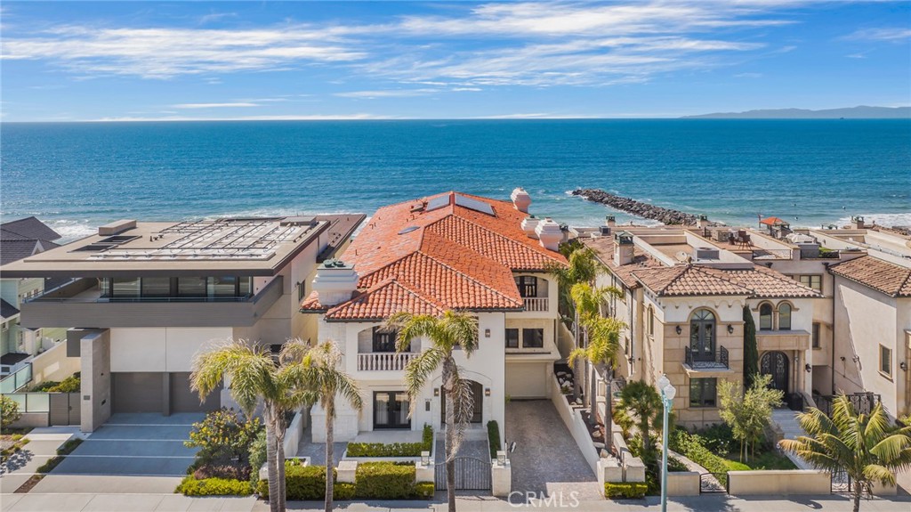 Nestled on the pristine shores of Redondo Beach, lies a magnificent oceanfront property of unparalleled grandeur. This luxurious retreat offers the ultimate coastal living experience, boasting a mesmerizing fusion of exceptional craftsmanship, breathtaking panoramic views & modern sophistication. The expansive 8,944 sqft of living space offers an exceptional level of comfort, with 6 spacious bedrooms & 6 lavish bathrooms, all meticulously designed to perfection. As you enter this stunning 3-story masterpiece, you are immediately greeted by a grand foyer that welcomes you with an abundance of natural light cascading through the sky lights. Adjacent to the foyer is the formal living room where you'll find stunning built-in bookcases & an impressive wine room. As you make your way into the main level, you will be awed by the soaring ceilings, floor-to-ceiling windows, & accordion doors that create a seamless indoor outdoor living experience. The gourmet kitchen is a true chef's delight, with top-of-the-line appliances, oversized island, custom cabinetry, and sleek countertops that create an inviting and functional space. Retreat to the luxurious primary suite, complete with a private balcony overlooking the coastline, a spacious walk-in closet, and a spa-like bathroom that overlooks the waves. Descend to your own personal oasis in the bottom floor great room which boasts a custom bar, full guest suite, and expansive outdoor patio overlooking the ocean- a space perfect for entertaining or relaxation, the possibilities are endless! The elevator provides convenient access to all floors of the home, while the 8-car garage provides ample parking for both residents and guests alike. Step outside onto one of the 6 outdoor patios and you will be instantly enveloped by the fresh sea breeze and panoramic views that stretch from Palos Verdes to Point Dume in Malibu. South Redondo Beach is a highly coveted community known for its natural beauty, award-winning schools, wide sandy beaches & amazing dining, shopping & entertainment options. Its mild climate provides limitless possibilities for outdoor activities like surfing, hiking, beach volleyball & paddle-boarding year-round. 709 Esplanade offers the perfect vantage point to experience all the wonders of this idyllic coastal enclave. Don’t miss this once-in-a-lifetime opportunity to own a true oceanfront masterpiece that blends luxury, comfort, and style into an unforgettable living experience.