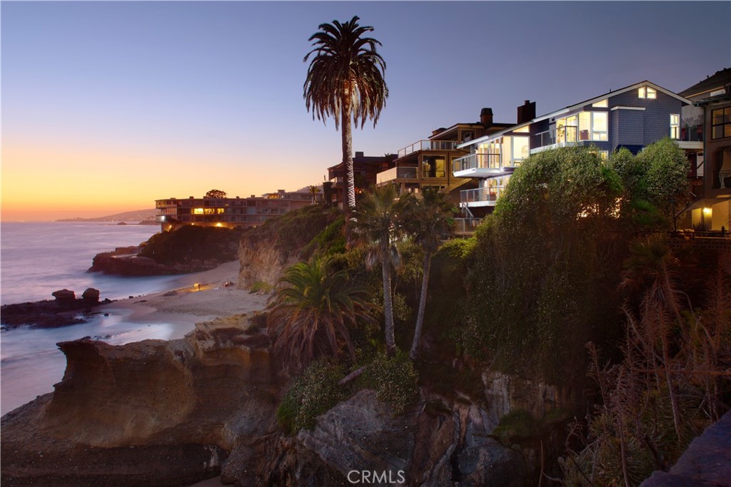 Unobstructed oceanfront views are just one of the countless rewards you'll enjoy at this extra-bright, newly remodeled residence in South Laguna Beach. The homesite is perched on cliffs above a rocky point of land and offers panoramic views of the Pacific Ocean, including breaking waves, sunsets over Catalina Island, and one of the few natural rock arches along the California coast. The main house features a four-bedroom, four-bath layout and provides access to Table Rock Beach. A one-bedroom, one-bathroom casita adds an additional appx. 424 SF, bringing the total conditioned living space to appx. 3,361 SF. Built over five levels, this home is filled with natural light and boasts nearly 2,000 square feet of fabulous decks. Almost every room offers oceanfront decks and direct views of the Pacific. Mesmerizing sit-down ocean views embellish the entire main living area, where floor-to-ceiling windows and glass doors open to a wraparound deck with ample space for large-scale gatherings.
Indoor entertaining is equally impressive, thanks to a magazine-caliber kitchen with quartz countertops, ample cabinetry, an island with bar seating beneath designer pendant lights, and stainless-steel appliances, including a Bertazzoni six-burner cooktop and a KitchenAid refrigerator/freezer and dishwasher. The lofty ceilings continue into the primary suite, located on the main level, which includes an en suite bath with marble countertops, a spacious walk-in shower, and a bonus area that can be used as a walk-in closet. On the middle level, there is an additional bedroom with an en suite bath and a private balcony, a secondary bedroom, a full bath/powder room, and an oversized laundry room. The next level features a separate family room anchored by a fireplace, with sliding doors that open to a deck with awe-inspiring ocean views. The final level includes a full bedroom and bath that could be used as a home office. The two lower levels open to an enormous private deck overlooking the ocean. The detached casita, featuring a separate entrance off the courtyard, includes a walk-in shower and abundant natural light. The two-car garage and carport provide ample off-street parking. This home’s prime location is minutes from the Montage Resort and golf at The Ranch. Laguna’s Main Beach is only a short distance up Coast Highway, and Monarch Beach and Dana Point await to the south.