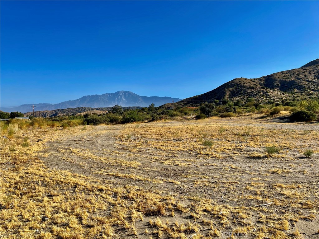 Nestled on a sprawling 4.5-acre canvas, this remarkable parcel unveils an awe-inspiring vista of majestic Mt. San Jacinto, its snow-capped peaks painting a picture-perfect backdrop that evolves with the seasons. Located conveniently off a main road, accessibility is seamless, with the added advantage of a pre-installed WATER METER and nearby power infrastructure, ensuring both convenience and feasibility for your dream project.
In this coveted locale, visionaries and builders alike are drawn to the allure of this panorama, where bespoke new constructions harmoniously blend with the natural grandeur. The surrounding sanctuary of the Sand to Snow National Monument enfolds you in a tapestry of protected montane and desert ecosystems, promising tranquility and preservation.
For the outdoor enthusiast, the possibilities are boundless. Trails weave through the landscape like threads of adventure, inviting exploration on foot, bike, or horseback in every direction. This oasis of calm resides at the southern end of Morongo Valley, offering not just a place to call home, but a gateway to effortless commutes towards the vibrant Lower Desert Cities.
Discover a haven where panoramic perfection meets practicality, and every sunrise brings a new masterpiece. Embrace the essence of Southern California living at its finest, where nature's beauty and modern convenience converge in a setting that promises both serenity and inspiration.