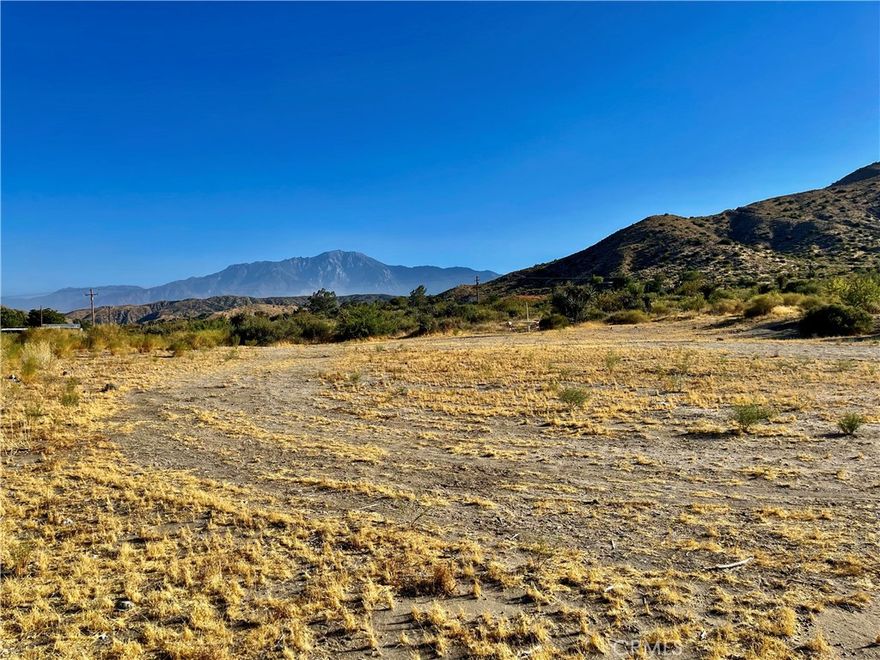 Nestled on a sprawling 4.5-acre canvas, this remarkable parcel unveils an awe-inspiring vista of majestic Mt. San Jacinto, its snow-capped peaks painting a picture-perfect backdrop that evolves with the seasons. Located conveniently off a main road, accessibility is seamless, with the added advantage of a pre-installed WATER METER and nearby power infrastructure, ensuring both convenience and feasibility for your dream project.

In this coveted locale, visionaries and builders alike are drawn to the allure of this panorama, where bespoke new constructions harmoniously blend with the natural grandeur. The surrounding sanctuary of the Sand to Snow National Monument enfolds you in a tapestry of protected montane and desert ecosystems, promising tranquility and preservation.

For the outdoor enthusiast, the possibilities are boundless. Trails weave through the landscape like threads of adventure, inviting exploration on foot, bike, or horseback in every direction. This oasis of calm resides at the southern end of Morongo Valley, offering not just a place to call home, but a gateway to effortless commutes towards the vibrant Lower Desert Cities.

Discover a haven where panoramic perfection meets practicality, and every sunrise brings a new masterpiece. Embrace the essence of Southern California living at its finest, where nature's beauty and modern convenience converge in a setting that promises both serenity and inspiration.