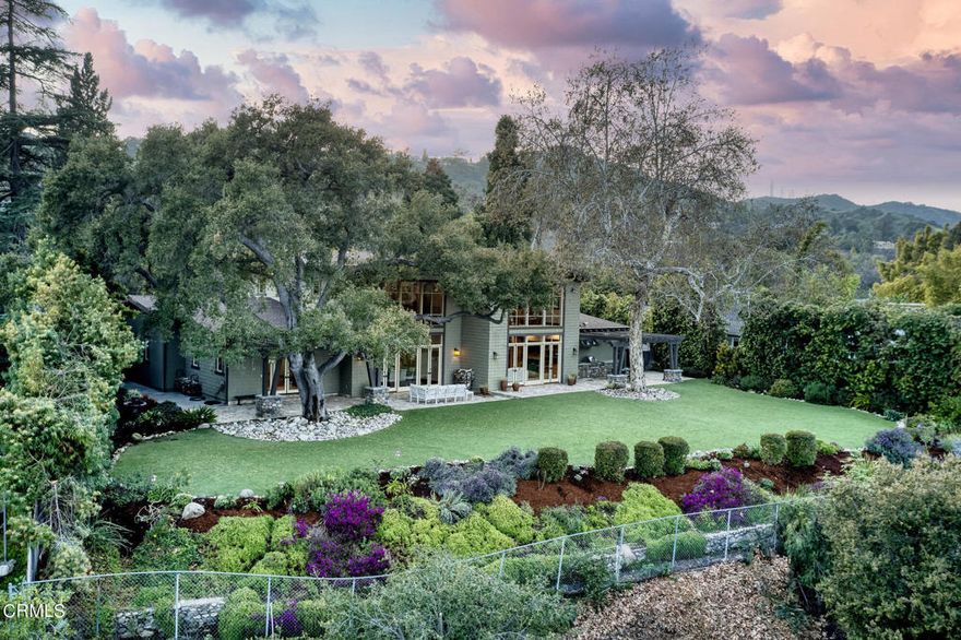 Located on the west bank of the arroyo, you will be mesmerized by stunning views of the San Gabriel mountains as well as the iconic Rose Bowl and Brookside Park field. This phenomenal custom-designed contemporary Craftsman exudes style and elegance while delivering endless comfort and easy, elegant living! Pass the captivating river-rock-clad entry with a fluted glass door to discover a remarkable interior showcasing exceptional craftsmanship, luxurious living spaces, soaring 22' ceilings, floor-to-ceiling windows, polished distressed oak and multi-colored slate floors, and Craftsman architectual/design touches throughout. Across the main gathering areas, multiple windows allow abundant natural light. Verdant sceneries make an ideal backdrop while entertaining guests around the majestic river-rock fireplace in the living room or hosting dinner festivities in the adjoining dining area. Enjoy a seamless flow into the kitchen where stunning slate tile flooring leads into the family room. The home chef can converse over the generous-sized island, which can seat 8-10 guests. Top-of-the-line Viking appliances and handsome shaker-style cabinetry complement the polished granite countertops and beautiful tile backsplash. In addition to generous cabinets in the kitchen, there is a walk-in pantry that offers additional storage for your cooking supplies and multiple selections of dishware. Cap off your dinner parties with refreshing beverages from the adjacent wet bar with wine cooler. Steps away, the family w/FP  & French glass doors.  Immerse yourself in the comfortable proportions of the sunlit bedroom suites with designer carpeting, large closets, & ceiling fans, the retreats create a restful space after a tiring day. Surpassing all, the fireplace-warmed primary suite has 2 walk-in closets with built-in organizing systems & direct access to an arbor-covered patio where you can appreciate spectacular panoramas of nature. Its exquisite tiled ensuite induces a spa-like feel with luxe twin vanities, a stand-alone shower, and an opulent soaking tub.. The home theater with a large screen, comfortable reclining loungers, & ambient lighting, is ideal for binge-watching movies with friends/family!. Perfect for indoor-outdoor living, the generously sized backyard has an outdoor kitchen & multiple patios. The attached 3 car garage has good storage workshop area & utility room. Located in coveted Linda Vista, this rare opportunity awaits you!