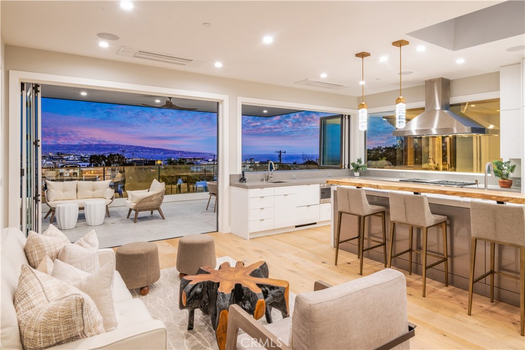 Steve Lazar’s most recent creation is the epitome of Coastal Living! Centrally located just blocks from the beach, award winning schools and world-class shops and restaurants, this incredible home offers panoramic views, amazing outdoor spaces and light filled interiors. A flexible floor plan creates a myriad of options with the four stop elevator providing access throughout. The top floor was designed with entertaining in mind… the open concept floor plan ensures a seamless flow throughout the living room, dining area, and gourmet kitchen, with walls of glass opening to the expansive covered balcony and panoramic views. The bedroom level includes a romantic primary suite with luxurious bathroom, along with a separate wing with 3 additional bedrooms. The expansive entry level includes a spectacular great-room, complete with wet bar, temperature controlled, glass wine room and glass doors to the front yard. Flooded with natural light, the basement level has 2 bedrooms, 2 bathrooms and a separate living room with “kitchenette”. Some of the essential amenities include a spacious 3-car garage, air-conditioning, 7.1 surround sound, lush landscaping and a captivating, tropical vibe. Whether entertaining or simply enjoying time at home, this meticulously designed and superbly executed home is a rare opportunity.