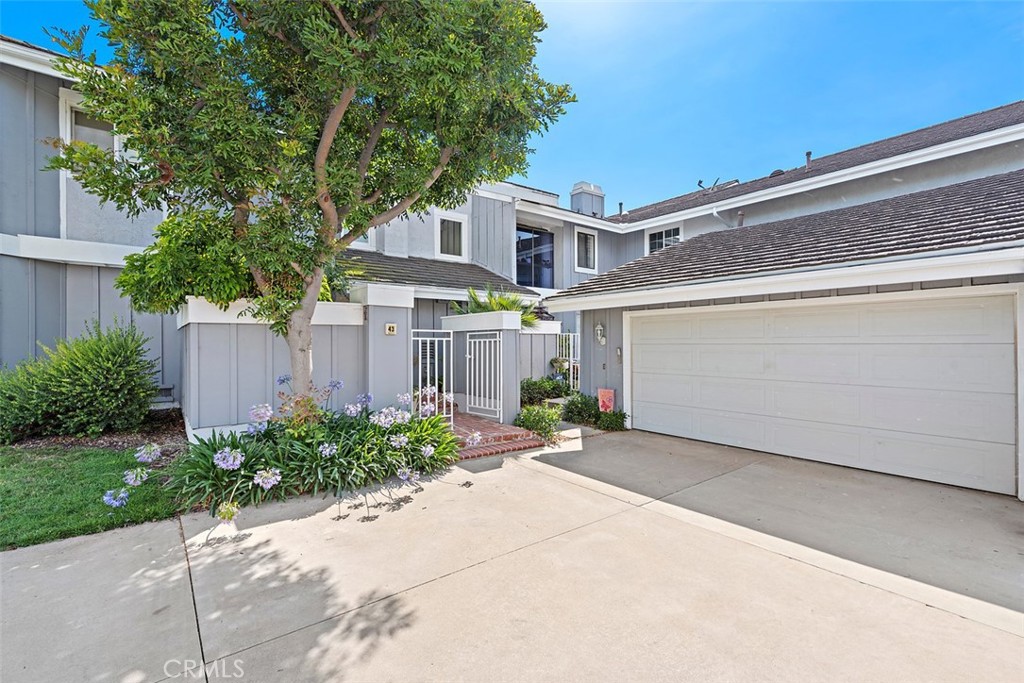 Step into a chic and elegantly remodeled home, nestled within the coveted "Inside the Loop" location. 2 PORTABLE AC UNITS WILL BE PROVIDED. As you enter through the secure gated courtyard, one of two intimate outdoor spaces, you'll be greeted by polished wood flooring and a neutral palette complemented by updated windows and doors. The kitchen, (fridge included), a bright culinary haven, boasts contemporary white shaker cabinets, gleaming quartzite countertops, top-tier stainless-steel appliances and a dedicated built-in for your prized wine collection. The adjoining breakfast area, illuminated by a grand window display, is ideal for peaceful morning moments. Both the spacious living room with its brick-accented fireplace and the formal dining area offer captivating views of the expansive private patio. Easily transition outdoors through the living room's sliding doors to experience a serene setting, enhanced by lush landscaping and a shaded patio. Comfort extends to the bedrooms. The primary suite features an updated bathroom with sleek quartz counters and dual sinks. The second bedroom doesn't fall short, boasting a similarly refined ensuite bathroom. Enjoy the convenience of an indoor laundry area, complete with washer and dryer. Living here provides access to Woodbridge's unparalleled amenities, including 44 parks, 2 pristine lakes, 24 tennis courts, and 22 refreshing pools. Plus, you're merely a short stroll away from the exclusive North Lake beach.