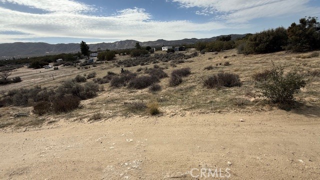 Come take a look at this fantastic lot, ready for someone to create their dreams, with views in all directions this very gentle sloping but mostly flat and usable lot is set in a perfect location to enjoy the seasonal weather this area offers. It is very close to the paved road for easy access. Utility poles are there to pull in saving costs.