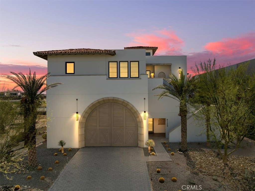 Experience the ultimate fusion of luxury and adrenaline at The Thermal Club, the premier private motorsports community in the heart of the desert. This stunning turnkey On-Track villa offers 8,575 square feet of meticulously designed living (5,651 SF) and garage space (2,924 SF), perfectly positioned to capture breathtaking mountain views and five miles of private racetrack from your expansive deck.
Designed for the true automotive enthusiast, this 4-bedroom, 7-bathroom estate features an impressive garage accommodating up to 12 cars, complete with an auto lounge, theater, full bathroom, and ample storage. Each bedroom boasts an ensuite bathroom, with additional half baths on every level for convenience. This home lays on an oversized 11,640 SF lot.
Elevate your lifestyle with a three-stop elevator that brings you to the top floor, where a sleek modern kitchen, spacious great room, elegant dining area, primary suite, guest room, and a private balcony await. Enjoy seamless indoor-outdoor living and soak in the mesmerizing desert sunsets.
This exceptional home offers a prime location with no immediate western neighbor and is just a minute's walk from the club’s world-class amenities, including two clubhouses, three restaurants, banquet & meeting facilities, a full-service spa & state-of-the-art fitness center, and a 48-casita hotel for guests. Recreational options include pools, tennis, pickleball, karting & a kids’ club.
Membership at The Thermal Club is required, with a $250,000 initiation fee, $2,400/month in dues, and a $350/month lot maintenance fee. Ideally situated just minutes from Palm Springs International Airport, with adjacent FBO access for private and commercial-sized jets, this one-of-a-kind villa is also a convenient drive from Los Angeles and Orange County.
For those who demand speed, luxury, and exclusivity, this is more than a home—it’s a lifestyle. Schedule your private tour today.