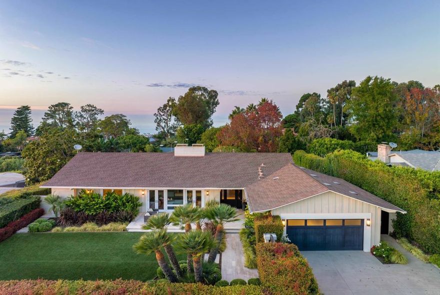 Set privately behind a pedestrian entry gate and mature hedge in the heart of La Jolla's Muirlands neighborhood, discover this wonderfully luxurious and comfortable custom home. It has horizon ocean views, an abundantly tranquil backyard with outdoor kitchen and firepit, plus a guest/pool house containing one bedroom suite and a gym with an accordion-style glass wall that opens to the gorgeous pool & spa. The main house has soaring open beamed ceilings, a great room concept with a large kitchen island adjacent to both indoor & outdoor dining areas, and yet another accordion-style glass wall and picture windows that frame the verdant tree tops and horizon ocean vistas. A large media or living room with one of the two fireplaces opens through french doors to a spacious front patio and yard that enjoys a rare combination of southern exposure, Pacific Ocean and some distant evening lights views, all while remaining just as private as the backyard. Of the three bedrooms in the main house, two share a bath that is in addition to the nicely appointed powder room, and the primary bedroom has a large bathroom ensuite with dual vanities, a spacious steam shower and walk-in closet. Practical features such as a large storage room off the oversized garage, big laundry room (with dual washers/dryers) perfectly located adjacent to the garage, walk-in pantry and kitchen, and smart home features throughout are just a few conveniences not to be overlooked. Its appealing mid-century style and roofline is a nod to its original, timeless design, while a recent "down to the studs remodel" created a high quality, custom and modern living experience. The .43 acre lot backs up to a paper street enhancing the privacy and expansive feel, and the understated curb appeal on coveted Inspiration Drive adds a touch of prestige to this ideal La Jolla home, perfectly complementing its exceedingly attractive features!