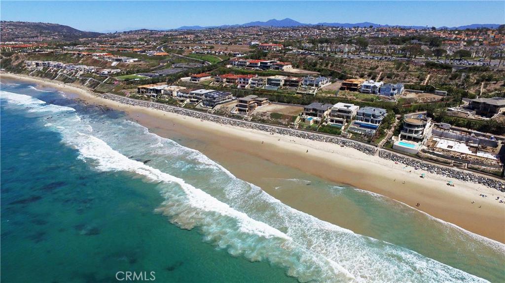 A rare opportunity to own one of the best oceanfront lots at the Strand at Headlands. This lot could also be purchased with the neighboring lot 55, putting the two lots together would create a double lot offering 140 feet of ocean frontage with amazing white water and white sand views. The two lots together are priced at $24,950,000. Build your own custom estate and enjoy views stretching from the iconic Dana Point Headlands to Catalina and beyond to Palos Verdes. This custom home site is located in the prestigious guard gated community, The Strand at Headlands, Southern California's most elegant beach front community. The home site is situated steps away from 1.5 miles of The Strand beach while the community is surrounded by nearly 70 acres of open space, parks, and trails. Enjoy the private Strand Beach Club amenity with bar, lounge, state-of-the-art fitness center, pool and spa. The Strand at Headlands is only a few minutes from Laguna Beach and Orange County s finest hotel resorts The Monarch Beach Resort, The Ritz Carlton, The Montage and in close proximity of the airport, golf course and harbor.