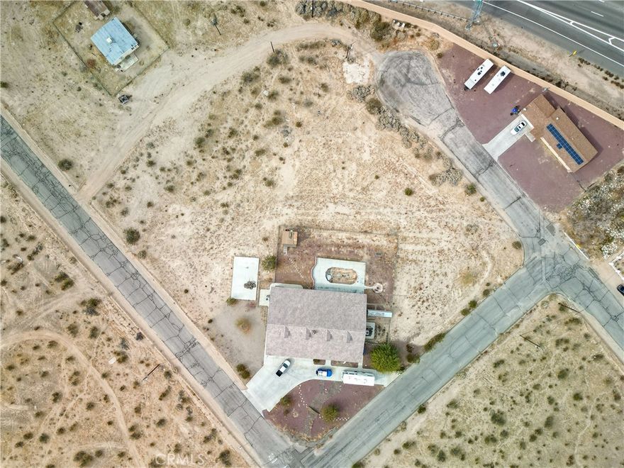 In a year or two you might wish you bought this 2.5 acres with this home nestled on this corner lot. The cost to build is hefty and this might be the answer to owning a newer home with acreage. Plenty of room for RV storage or to build another home. This is a split floor plan with 3 rooms on the East end of the home and the master suite on the West end. All the rooms are spacious in size. The living room, family room, and kitchen are perfectly centered for large gatherings. There is space to Re-insert a above ground pool with the concrete around it. So, if building a new home is on your agenda, wait and look here first. Very affordable property.  The photos of the inside of the home are virtually staged.