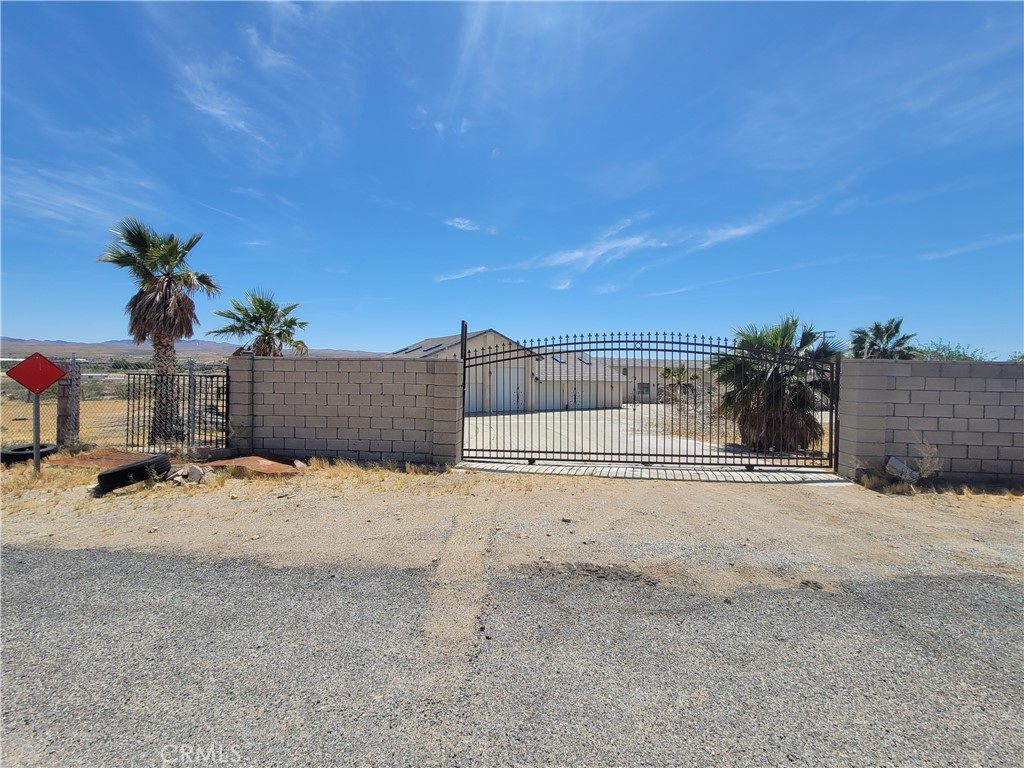 This Pristine Estate home is like having your own private resort to wake up to every day. The main house has five bedrooms and three bath rooms with lots of entertaining space as Well. The house has A huge family room that over looks the pool in the back yard . There is A
separate living room and formal dining room area with A nice poker room with A cozy fireplace. The kitchen has granite counter tops and is open to living room . The master suite has A separate sitting area with its own private bathroom with A huge tub and separate walk in shower. Two of the other rooms have separate bathrooms and are very spacious. The other remaining bedrooms are oversized. There is Also a Pool house with two bedrooms and two baths and A kitchen area that over looks the resort pool area. There is paid off Solar with a lot of panels that comes with the home. The back yard is your own private oasis with A huge pool with built in seating that is surrounded by Huge rock grotto, there is A slide, Jacuzzi also A nice built in BBq area . The property is fully gated for privacy and has A lot of mature palm trees with Lots of parking on a circular driveway and Huge garage that can hold up to ten cars with A RV garage as well. The house has its own Water well. The land size is very large with over three acres , The large lot is private and gated.