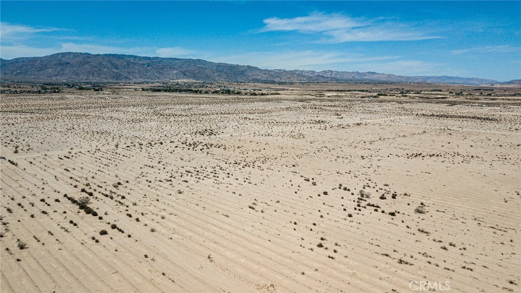Discover an incredible opportunity with this 40-acre parcel nestled within the vibrant city of Twentynine Palms. This expansive property offers a blend of natural beauty, strategic location, and essential utilities nearby, making it an ideal canvas for your vision.
The parcel includes a deeded interest in two wells located just to the east on the adjacent 10-acre parcel. While the condition of these wells is currently unknown, they offer potential additional water resources. For your convenience, there are water lines at the road available on the southwest corner of Indian Trail and Sherman Hoyt, providing essential infrastructure for development or agricultural use. Electricity is approximately 660 feet from the property, facilitating the installation of power for various uses.
Situated in Twentynine Palms, this property benefits from close proximity to the city's amenities, including shops, restaurants, and cultural attractions. Its expansive size allows for a range of possibilities, from residential development to agricultural projects or recreational ventures. The surrounding desert landscape offers stunning views, peace, and a unique connection to the natural beauty of the Mojave Desert.
This 40-acre parcel presents a rare chance to own a substantial piece of land with vital utilities close at hand in a growing and dynamic community. Whether you are looking to build a private retreat, invest in land, or embark on a new venture, this property provides the perfect foundation for your aspirations. Don't miss out on this exceptional opportunity to secure your place in the heart of Twentynine Palms.
Buyer to do all due diligence and investigations regarding the property