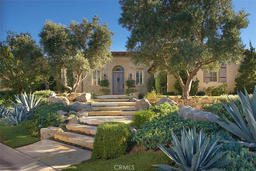 As if taken from the pages of Architectural Digest, this European-influenced custom estate takes living and entertaining to the next level blending the timeless romance of an Italian farmhouse with modern luxury. Perched at the end of a cul-de-sac on one of Shady Canyon’s highest promontories and bordered by a nature preserve, the home enjoys serene views from the expansive outdoor areas and covered loggias. The casually elegant interiors encompass 6 bedrooms and 6-and-two half baths; an indulgent subterranean level with a pre-wired theater, wine cellar, bonus room, bar, fitness center, large laundry room with hair salon, a guest living suite, and patio terrace; as well as expansive resort grounds with a beautiful pool and spa, outdoor shower, emerald lawns, natural stone fire pit, Bocce ball court and barbecue facility with sink and icemaker. Additional custom features include French limestone and wide plank French oak hardwood floors, Calacatta Vagli and Carrera marble counters and reclaimed wood beams. Residents of Shady Canyon enjoy world-class amenities and close proximity to award-winning Irvine schools.