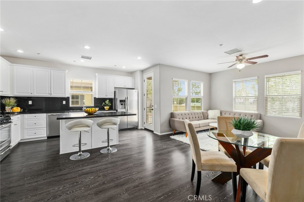 The ONLY condo for sale in OC with a three-car garage, all the living space conveniently on one level (level 2), and an abundance of light throughout the entire unit...This end-unit Colony Park floor plan is incredibly rare and unique. Enter this condo from the gated front entrance on Santa Ana St or through the 3-car direct access garage. You are greeted with a formal entry, which houses a large walk-in storage/coat closet and staircase to the main living space. Upstairs, you will find the open floor plan living area with spacious kitchen w/large island, black granite countertops, stainless steel appliances & Thermofoil cabinets with ample storage space. The kitchen is also open to the dining room, living room and has access to the private balcony. Down the hall, you'll find a full guest bathroom with plenty of counter space & a separate room for the shower/toilet. You will also find the two secondary bedrooms, laundry room and primary bedroom suite. The massive primary bedroom houses a walk-in closet and en-suite bath, equipped with stand-up shower, oversized soaking tub, dual sinks & separate toilet room. The 3-car garage is perfect to park 3 cars or use the 3rd space to create a gym, office, bonus room or whatever your heart desires! This home also features laminate & tile flooring, brand-new plush carpet with upgraded padding, tankless water heater, water softener, ceiling fans in each room and has been freshly painted. Windows are mostly west-facing with 2 north facing windows, so this unit stays beautifully bright in the afternoon. Colony Park’s low association dues include: 3 pools, 2 spas, 3 clubhouses, BBQs, fire pits, security, fitness center, dog park, gorgeous landscaping and a neighborhood park. In addition to all the amenities, it is a few blocks from the popular Anaheim Packing House, Villains Brewery, Center Street Promenade and a quick drive to other attractions such as Disneyland, Angel Stadium and the Honda Center.