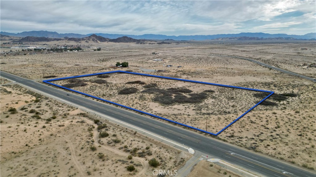 Welcome to an exceptional opportunity to own 18.19 acres of residential bliss nestled in the heart of 29 Palms. Spanning over 18 acres, this vast parcel provides ample space for realizing your vision. Whether you're considering building your dream home, establishing an equestrian estate, or crafting a serene getaway, this property offers the canvas upon which to create. Conveniently situated as a corner lot, this expansive parcel offers a multitude of possibilities for your dream desert retreat. Its location in close proximity to the main entrance of the 29 Palms Marine Corps Base adds to its allure, providing easy access to the amenities of the base and the surrounding community. Ideal for military personnel seeking a peaceful retreat close to duty, this location offers both convenience and opportunity. Embrace the tranquility of the desert landscape, enhanced by mature vegetation that adds character and charm to the surroundings. Experience the beauty of native flora and fauna as you immerse yourself in the unique ecosystem of the Mojave Desert. Whether you envision a private sanctuary away from the hustle and bustle of city life, a recreational haven for outdoor enthusiasts, or an investment opportunity with promising potential, this vacant lot presents endless possibilities to suit your desires. Seize the opportunity to own a piece of paradise in 29 Palms. With its desirable location, expansive acreage, and natural beauty, this property is a rare find that awaits your personal touch.