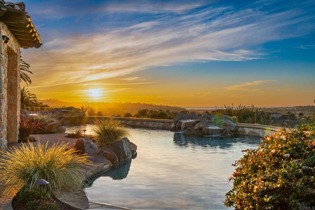 A premier ocean view site in the exclusive Rancho Pacifica guard-gated community showcases this exceptional custom-built estate. Indulge in panoramic views of the Pacific Ocean, Fairbanks Ranch Golf Course, and the breathtaking mountains to the east. A grand entry welcomes you this stunning jewel boasting beautiful floor-to-ceiling windows to take in the spectacular views from the elegant living and dining rooms. At the heart of the home the gourmet chef’s kitchen with dual islands, sunny breakfast nook, butler’s pantry, and large walk-in pantry connects to the family and billiard/game room with impressive wood beamed ceilings and large disappearing walls of glass seamlessly transition between indoor and outdoor living spaces, ideal for both large scale entertaining or more intimate gatherings. The functional floorplan includes seven spacious ensuite bedrooms, four on the main level including the sumptuous primary suite with a lavish spa-like bath, coffee bar and separate walk-in closets. Special features include a state-of-the-art theater with high resolution projector and screen, executive wood paneled office with fireplace, customized wine cellar, fitness room, Solar system, remote-controlled awnings, Savant and Sonos system, and high-speed Wi-Fi connection. Enjoy outdoor living at its finest; covered loggia with gas heaters and fireplace overlooking the manicured landscaping, sunlit pool, spa, water features, BBQ kitchen, cozy fire pit to relish in the picture-perfect sunset views, and an oversized 6-car garage with ample storage. Masterful design, meticulous detail, and mesmerizing views brilliantly combine in this exceptionally private property well located just minutes from North County’s best beaches, golf courses, restaurants, shops, the Del Mar racetrack, and more.