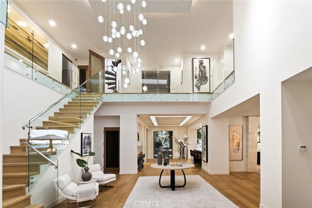Experience the epitome of luxury living at this modern coastal architectural masterpiece where the beach and elegance meet. This remarkable 6-bedroom, 5-bathroom beach estate offers breathtaking panoramic views of the ocean and coastline. Uniquely located in the desirable Hermosa Hill section on a private cul-de-sac and flooded in natural light, the open floor plan seamlessly integrates indoor and outdoor living throughout. Step into the double height entrance foyer, past the dining and family rooms, and into the spacious kitchen with an impressive island and top-of-the-line appliances as it effortlessly spills into the backyard. Ideal for entertaining with a large stone spa, built-in barbecue, fire pit and sitting area, this serene and quiet atmosphere with impeccable views is reminiscent of luxurious tropical destinations. Transition to the cozy living room which features stunning ocean views and a stone fireplace, while the exquisite dining room showcases lush outdoor landscaping, enhancing your dining experience. Upstairs the expansive primary suite welcomes you with a grand entrance, white oak floors, and captivating ocean views from two oversized en suite balconies. The suite includes a spacious and gorgeous walk-in and a spa-like bathroom that exudes luxury and tranquility. Additional rooms include a basement perfectly situated as a game room and screening room for gatherings and entertainment (an additional 900 square feet not included in total square footage), a gym area, office, and much, much more. This is a must-see one-of-a-kind estate with an unparalleled living experience from your own luxurious coastal retreat.