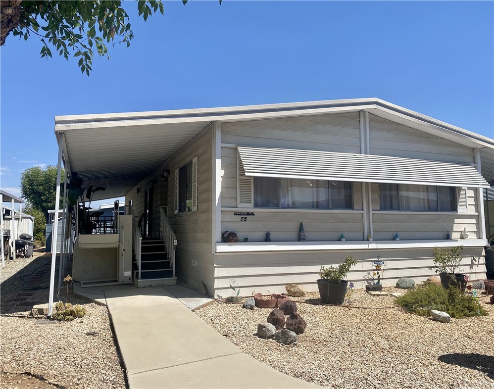 Welcome home! Lovely 2 bedroom 2 bathroom home in the 55+ community of Sun City Mobile Estates in Menifee. This manufactured home is spacious and open. There is plenty of cabinet space in the very large kitchen and lots of counter space. The refrigerator is included. Enjoy your mornings and relax in the evening on the patio/porch off of the sliding glass door from the family room. The primary bathroom has a walk-in tub with a shower. The laundry room includes a washer and dryer. Also included is a vertical platform lift near the stairs to the front door. Ample covered parking for two cars. Minutes from shopping and restaurants. Easy access to the 215 freeway.
