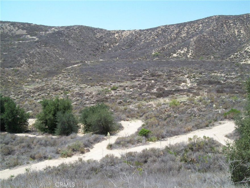 Beautiful, isolated rural 69.57 acre box canyon property in unincorporated Somis area of Ventura County, at Solana Verde Ranches.  Perfect for rural residential estate compound. Plans available for 9,000 SF main home, caretaker residence, tennis-racket ball courts & horse stables. Additional dwelling unit also possible. Avocado-citrus development possible including on slopes, subject to cost of water. Build your dream estate home in clean air, openspace Ventura County.  This is a gated community.
