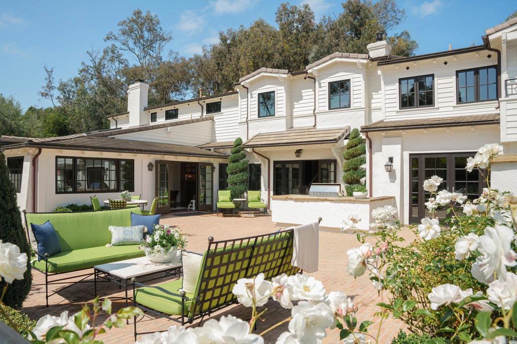 Rarely does a residence of such profound historical significance, effortlessly blending original features with contemporary conveniences, grace the San Diego market, especially within the Covenant of Rancho Santa Fe. This distinguished westside property seamlessly integrates its origins with modern comforts, extensive remodeling, and additional square footage. Offering not just a place to live but a lifestyle, featuring expansive indoor-outdoor spaces, 4 bedrooms, 4 and a half baths, and a three-car garage nestled on fully fenced 1.97 acres of meticulously landscaped grounds. Its enviable proximity to both the village and the coastline makes it ideal for embracing quintessential Ranch and Coast living. The original estate spared no expense from its inception, a tradition upheld during its comprehensive renovation in 2019. Over two years, every detail was carefully curated, merging contemporary amenities with the preservation of historical integrity. Original wood beams complement 18-inch masonry walls and hardwood floors that grace the sprawling 5,680 square feet of this residence. The expansive layout of the gourmet kitchen, family room, and dining area epitomizes modern-day living at its finest. Amenities include a fully equipped gym, a designer pool and spa, verdant gardens, and a sports field, fully approved through the RSF Association for a Pickleball Court. This residence offers unparalleled luxury, with numerous courtyards providing serene spaces for entertainment or reflection, enveloping residents in the distinctive ambiance of this extraordinary abode. Undoubtedly, this iconic home stands as a peerless masterpiece, seamlessly blending rich history with contemporary opulence.