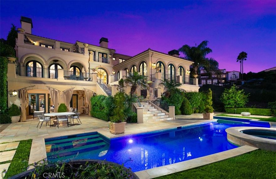 Savor unobstructed, glistening Ocean and Harbor views throughout by day before being captivated with a dazzling array of nighttime city-lights that embellish the California coastline with brilliance. This front-row, custom estate situated behind Newport Coast’s championed guard gated community of Pelican Hill welcomes guests with a dramatic dual staircase foyer and artisan bespoke finishes that evoke refinement and a level of grandeur rarely seen. The property offers approximately 9,610 sq ft of refreshed and updated living space accompanied by 6 bedrooms and 7.5 baths that make the estate ideal for residents with impeccable taste. This ocean view custom estate boasts an open floor plan which creates seamless transitions between the formal living space, dining room, kitchen, and outdoor spaces. The upper level is appointed with four en-suite bedrooms, including the lavishly appointed primary suite with sitting area, viewing terrace, steam shower, and oversized dream closet. The day-lit basement level features an executive gym with glass viewing wall, spa, and game room that all have rare ocean views thanks to the walk out french doors that offer direct access to the basement level covered loggia. An entertainer’s dream backyard is highlighted by a pool/spa finished with custom glass in-laid mosaic tile, outdoor bar and bbq island, covered loggia with fireplace, all which allows one the privilege of experiencing five-star resort living right in your own home. The property is rounded out with award winning schools, world class shopping and dining, and close proximity to multiple beaches. Timeless elegance found in every detail of this estate put this residence on par with the world class resort just down the road.