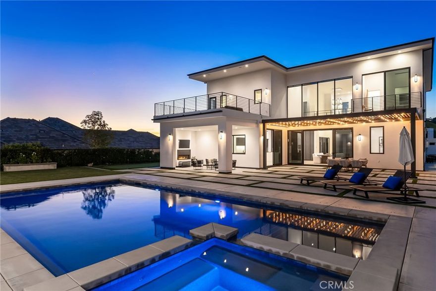 The pinnacle of modern luxury homes. Indulge in an affluent lifestyle with captivating views at this newer, contemporary estate with 2 bedroom detached guest/pool house, resort-style backyard and unsurpassed quality/design throughout. Fulfill your pursuit of a home that embodies all your desires at this striking architectural gem, tucked away at the end of a quiet cul-de-sac in an exclusive neighborhood. Completed in 2021, this custom estate rests upon a sprawling, elevated home site spanning 21,000 sq ft, offering breathtaking views of city lights, Palos Verdes Peninsula, and ocean in the distance. Step into a world of refined luxury across approximately 6,600 square feet of impeccable living space, where sleek lines, exceptional craftsmanship, imported fixtures, and exquisite materials converge. Step through the pivoting glass entry door and into approximately 4600 sf of open-concept living space in the main house, you're greeted by a stunning foyer boasting a 27-foot ceiling and dramatic floating staircase ascending to a hallway bridge above. The grandeur and towering ceilings continue into the Great Room and dining area with walls of glass, 10-foot telescoping doors and French oak hardwood floors that seamlessly integrate indoor and outdoor living. The top-tier kitchen, open to the great room, boasts a dual-waterfall island, quartz countertops, custom cabinetry, breakfast bar, dining nook, 2 pantries, separate prep kitchen, and Thermador appliances. A private office, powder room and guest suite with private bath are located on the main level.  Ascend the floating staircase to the primary suite with 14' ceilings, private view terraces, opulent bathroom with designer tile work, freestanding tub, dual walk-in closets, linear fireplace and sitting area to take in the inspiring views. 2 secondary en-suite bedrooms are located on the upper level in a separate wing. The allure of this residence extends to its outdoor oasis—a private resort-style backyard featuring a pool and spa, covered conversation area with fireplace, aluminum trellis with string lighting for alfresco dining, built-in BBQ,  fire pit and putting green. A detached guest house and pool cabana beckons with a full kitchen, a fireplace-warmed living room, 2 bedrooms, and 1 bath spread over approximately 2,000 square feet, ideal for multi-generational living or long term guests. Optional RV parking can be created. This modern masterpiece promises an unparalleled lifestyle of luxury and comfort