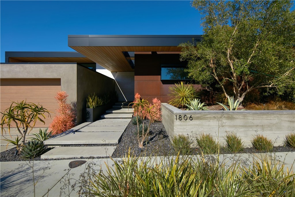 Cutting-edge architecture and interior design define this newly-constructed estate by LeTourneau Architecture and Hiebsch Custom Homes. The geometric rooflines and concrete block facade create synergy with the surrounding contemporary landscape while the coastal lounge atmosphere lends an exclusive air to this stylish retreat. Abound with meticulous architectural details, roof cutouts, sky lights, and custom Fleetwood windows and doors, the interiors are filled with warm natural light. Sleek living spaces unfold across approximately 5,300 square feet and organically extend to the tranquil outdoors where a California room hovers at the pool’s edge. The true gourmet kitchen is a chef's haven, equipped with Gaggenau and Miele appliances including an integrated coffee-maker, vacuum-sealing drawer, and wine refrigerator. Open to the backyard, the principal suite encompasses decorative flourishes and carefully sourced materials such as European white oak flooring and cultured limestone accents. Furthering the resort ambience are custom rift oak cabinetry adorning the master closet, and a zen-like bath welcoming in vistas of lush foliage. Amenities include built-in Triad speakers, Lutron lighting, J Geiger privacy/sun shades in every room, water & air purification systems and Control4 Home Automation with lighting, A/V, security, monitoring, and pool integrations. Impeccable design, unsurpassed comfort, and a premier location make this never-lived-in residence a dream offering.